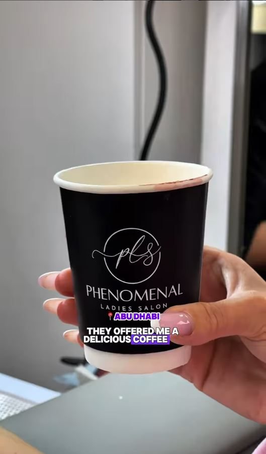 A branded coffee cup served to a client